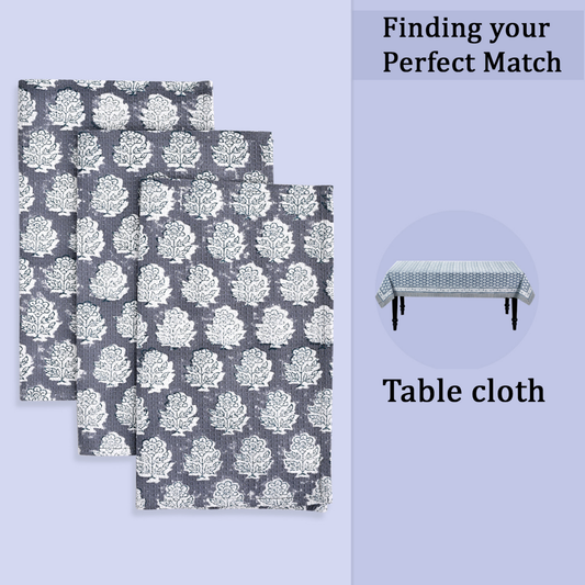 Set of three gray tablecloths with white floral pattern on a light purple background