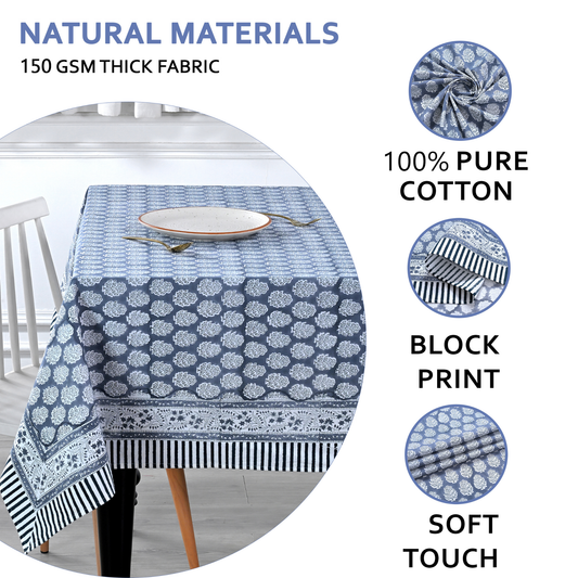 blue and white decorative cotton tablecloth with striped border on wooden table