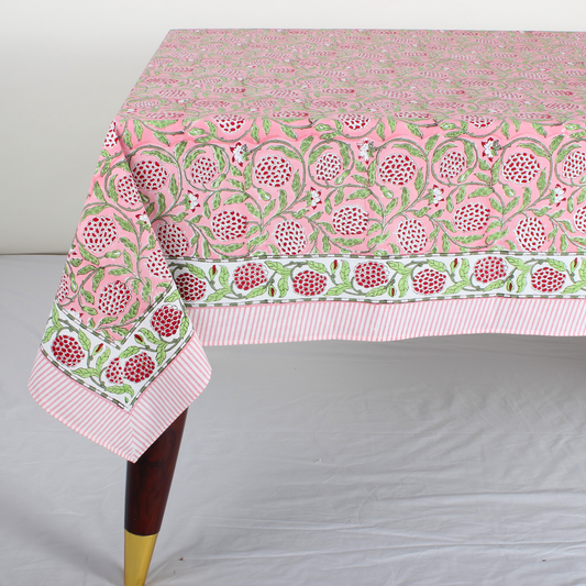 pink decorative tablecloth with striped border on wooden