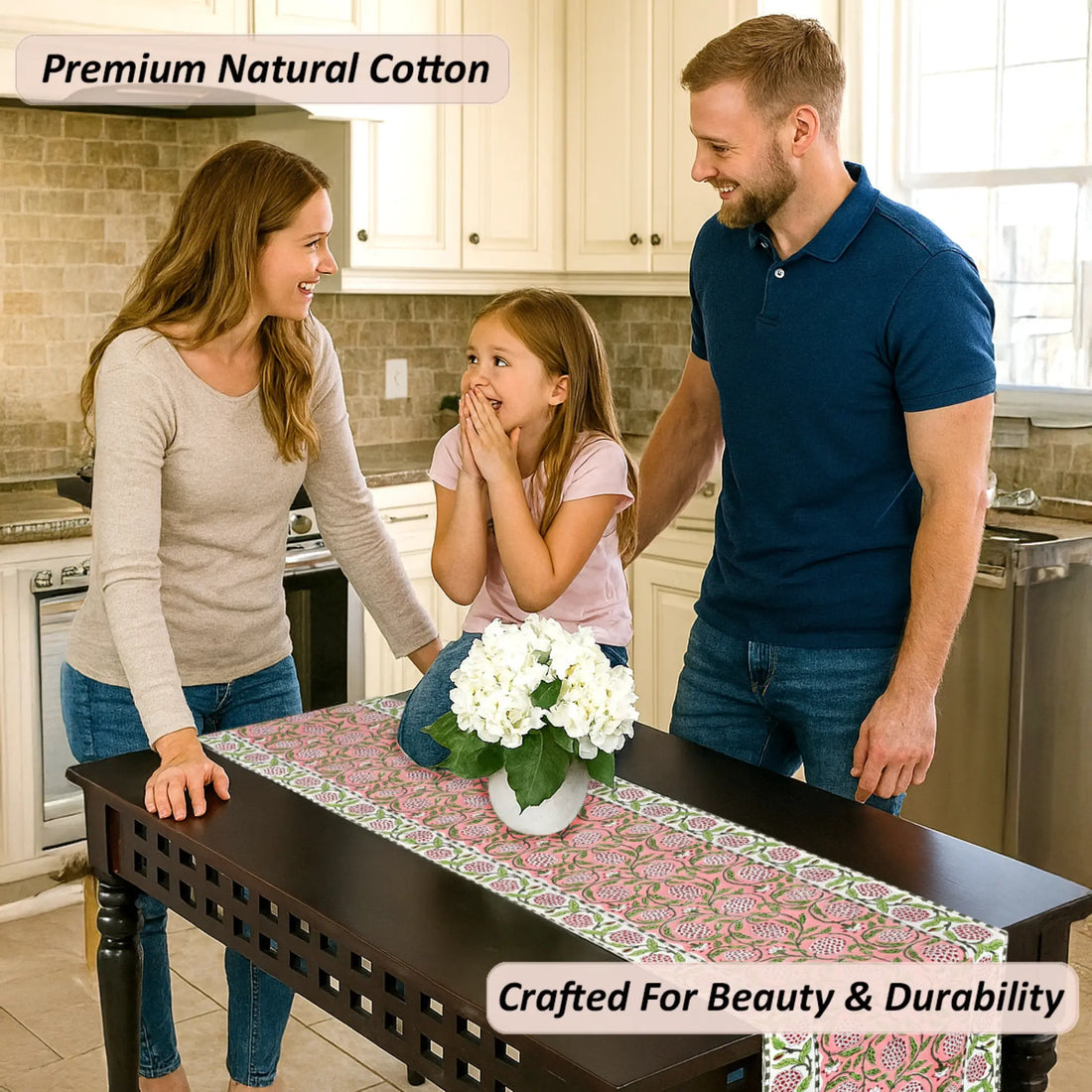 Family in a kitchen with a table runner featuring white flowers.