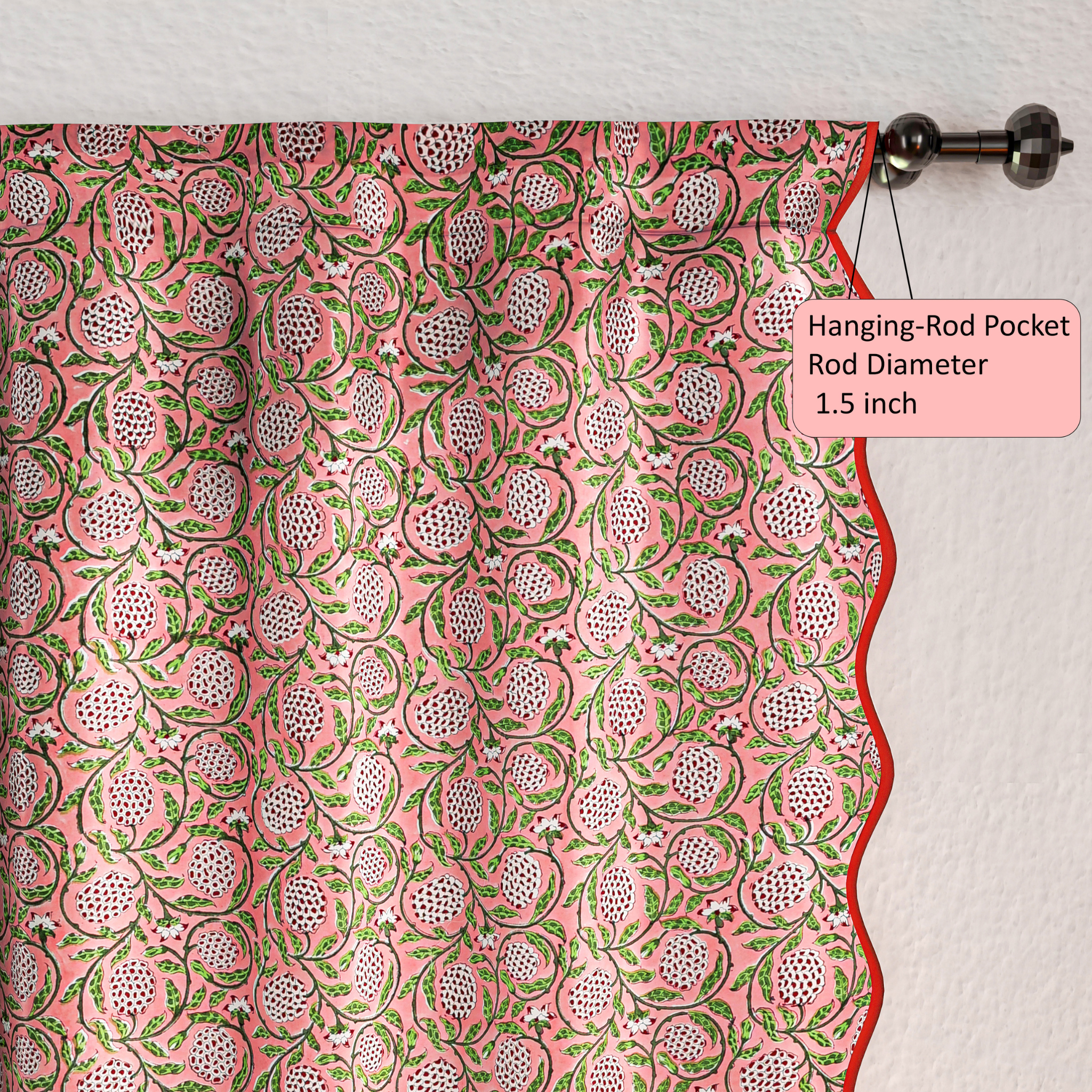 Curtain with pink and green floral pattern hanging on a rod with a label indicating rod pocket size.