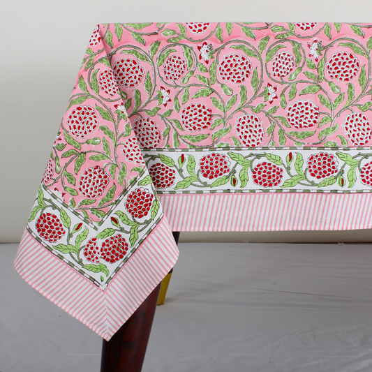 pink decorative tablecloth with striped border on wooden