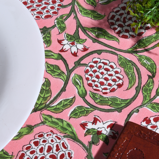 Close-up of a pink fabric with red and green floral pattern