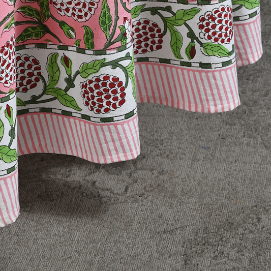 Close-up of a fabric with floral and striped patterns on a gray surface
