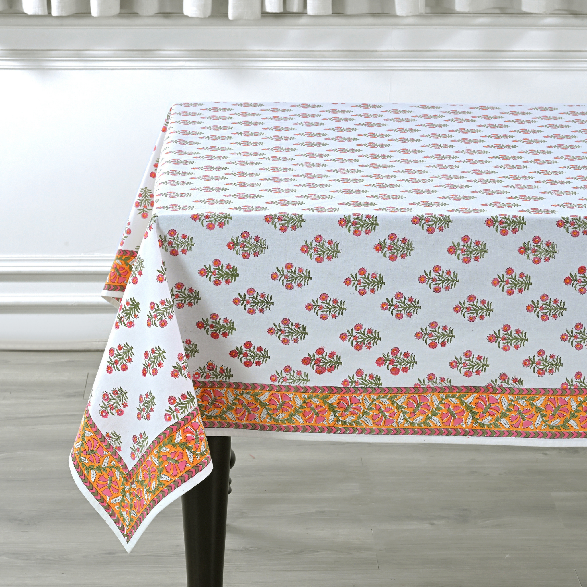 Floral patterned tablecloth on a dining table with a neutral background