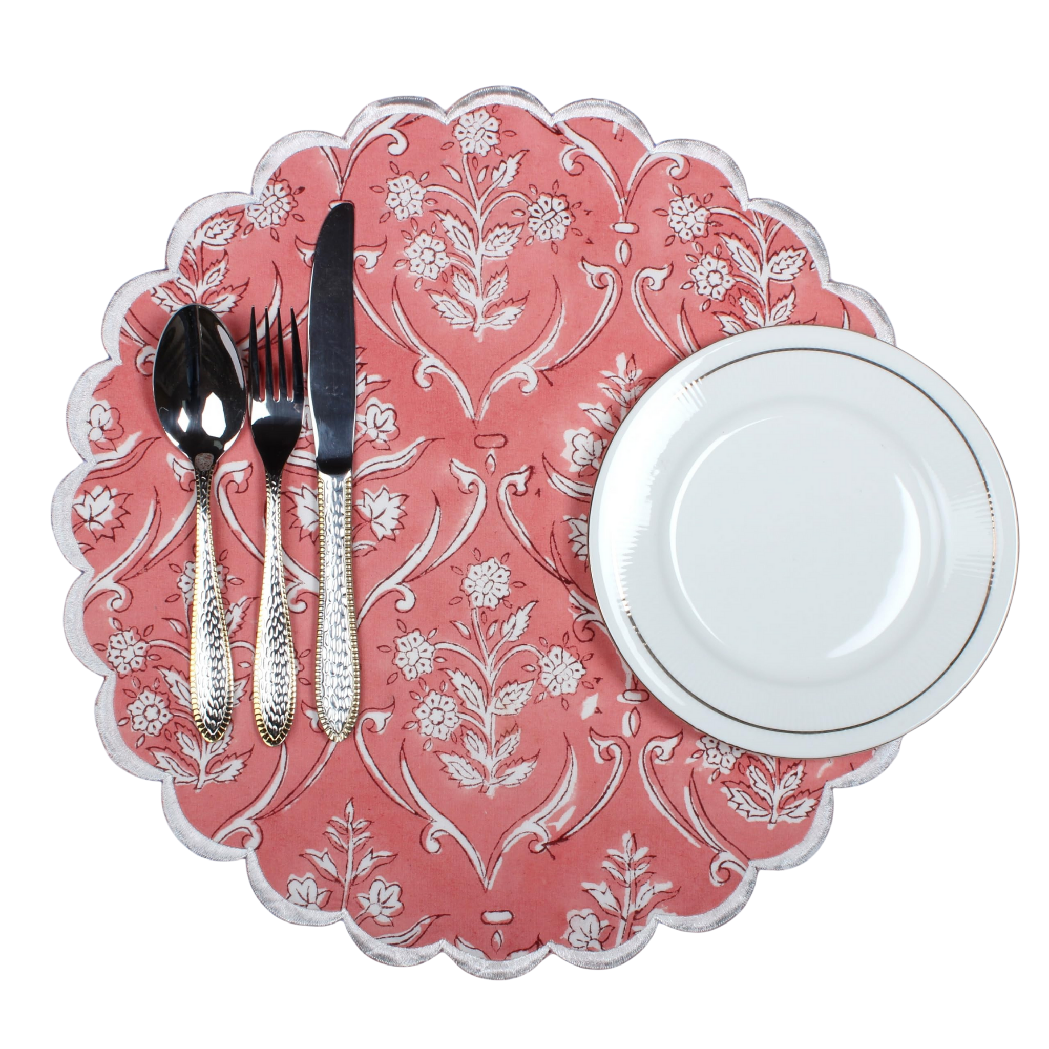 Decorative pink placemat with floral patterns, cutlery, and a white plate on a white background.