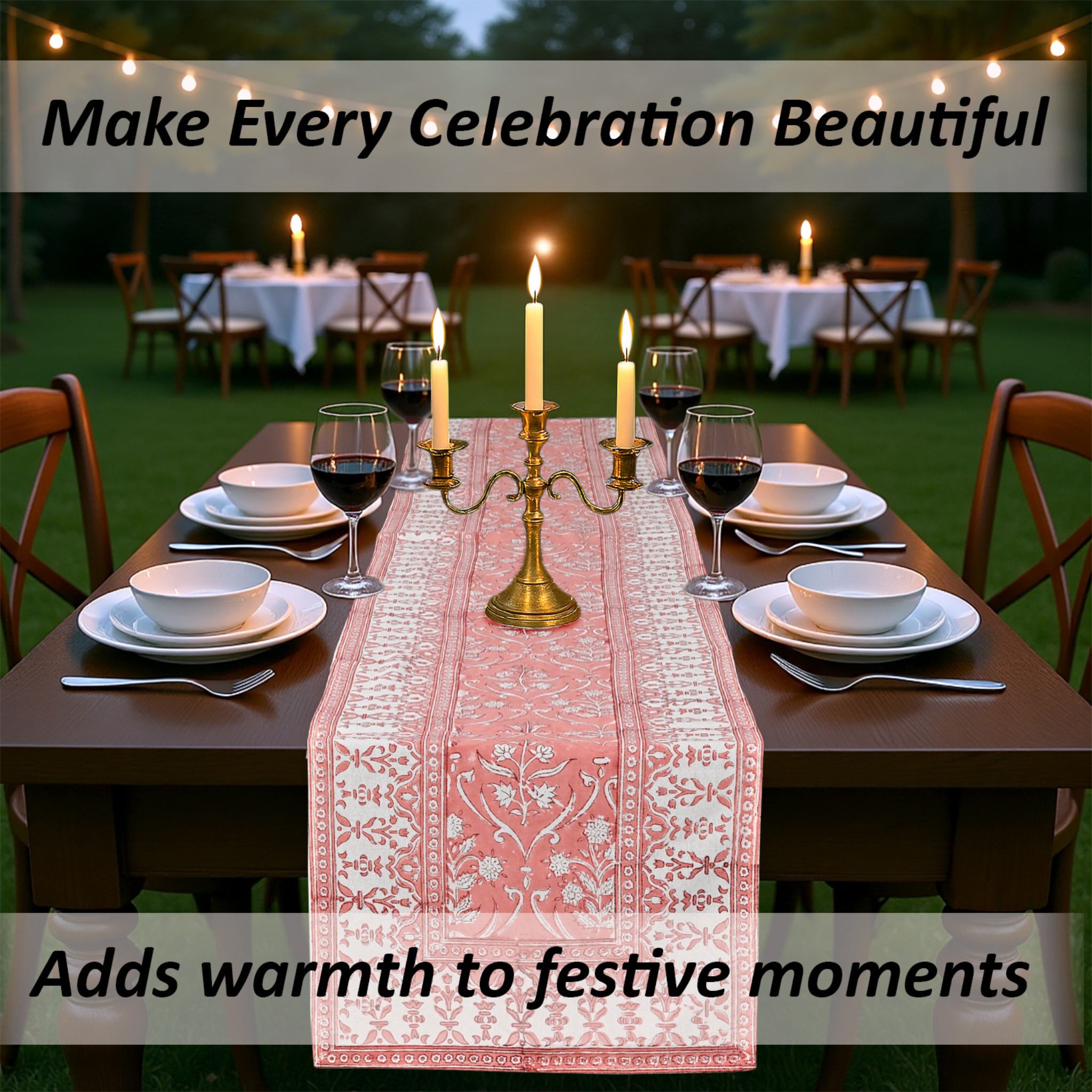 Dining table set for a celebration with a pink table runner, candles, and wine glasses outdoors.
