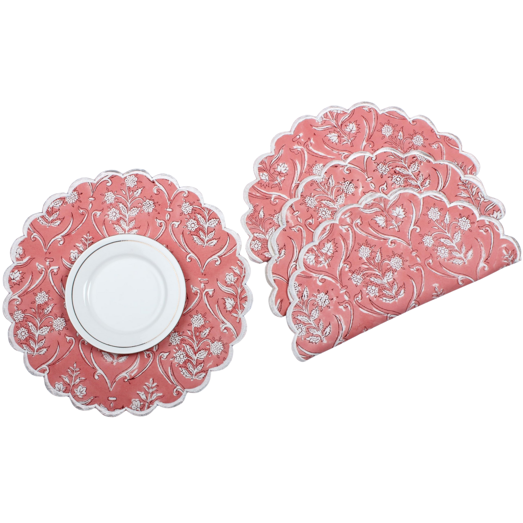 Set of pink floral placemats with a white plate on a white background
