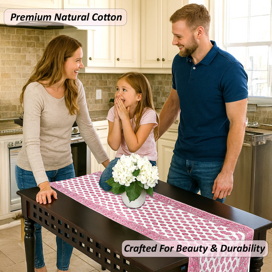 Family in a kitchen with a table runner featuring white flowers.