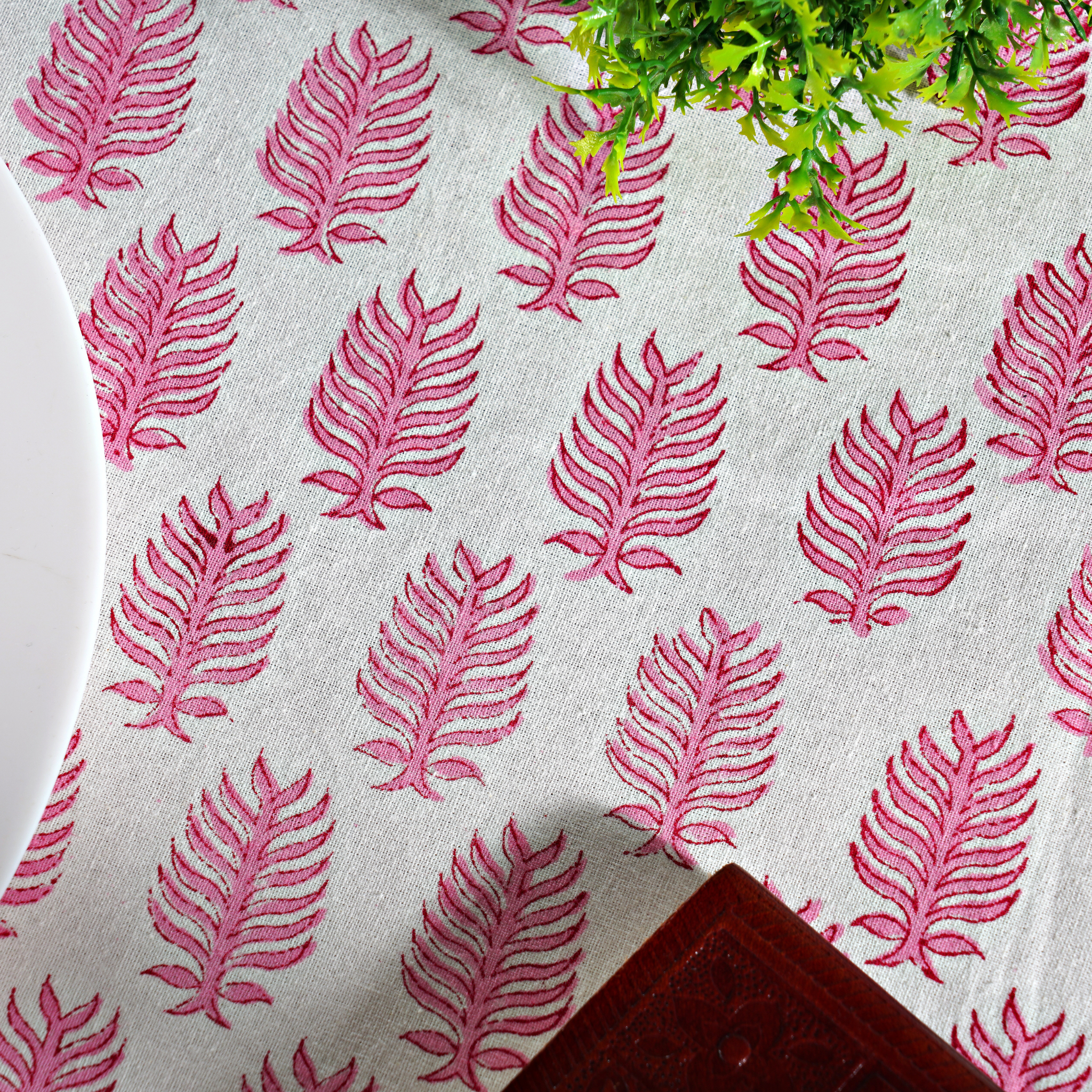 Fabric with pink leaf pattern on a white background