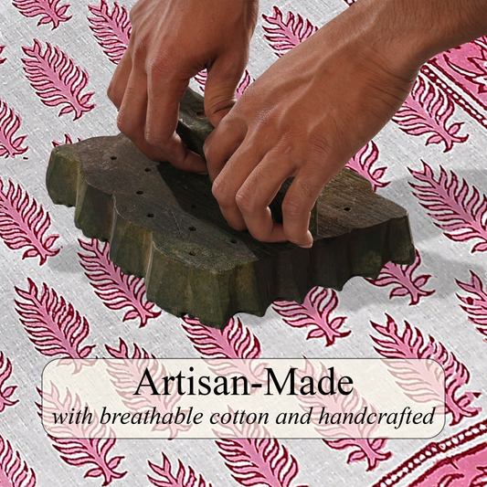 Hands using a wooden tool on a textured surface with pink feather pattern
