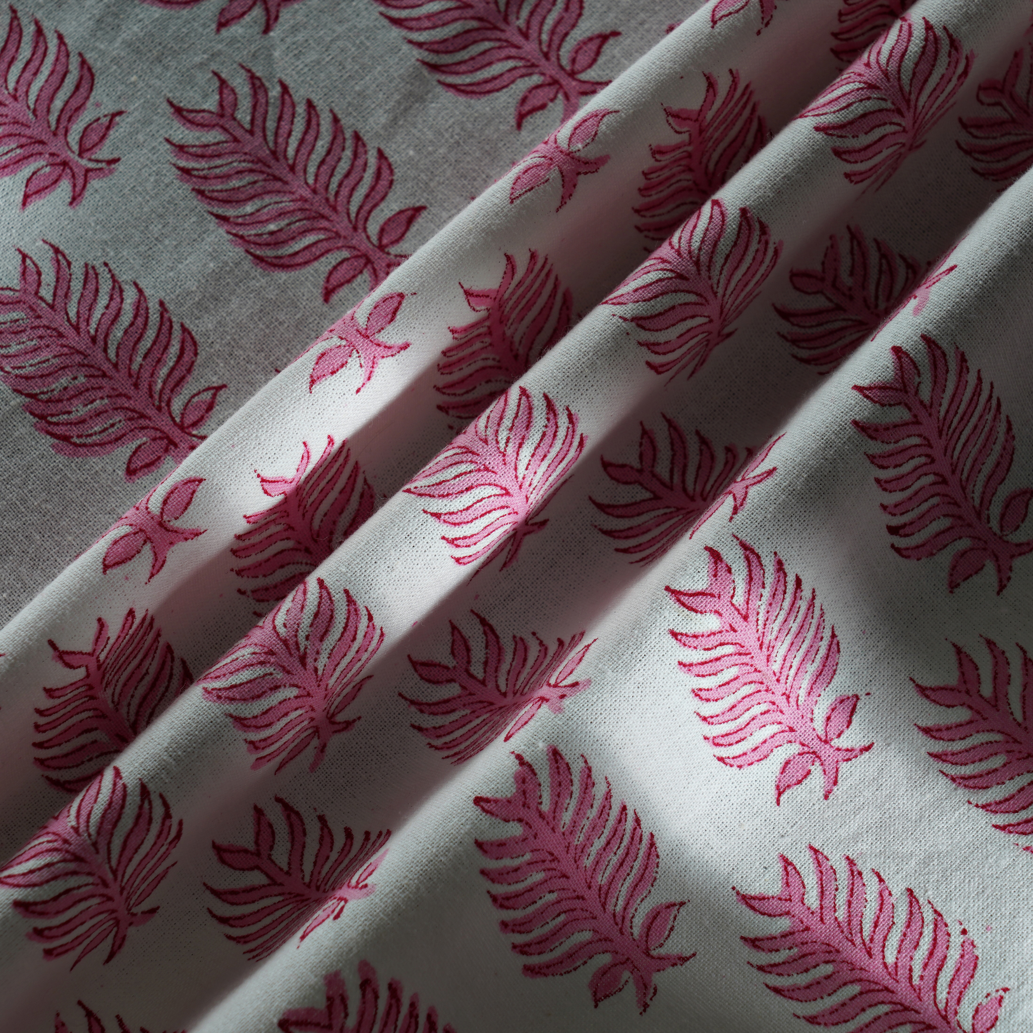 Fabric with pink leaf pattern on a white background