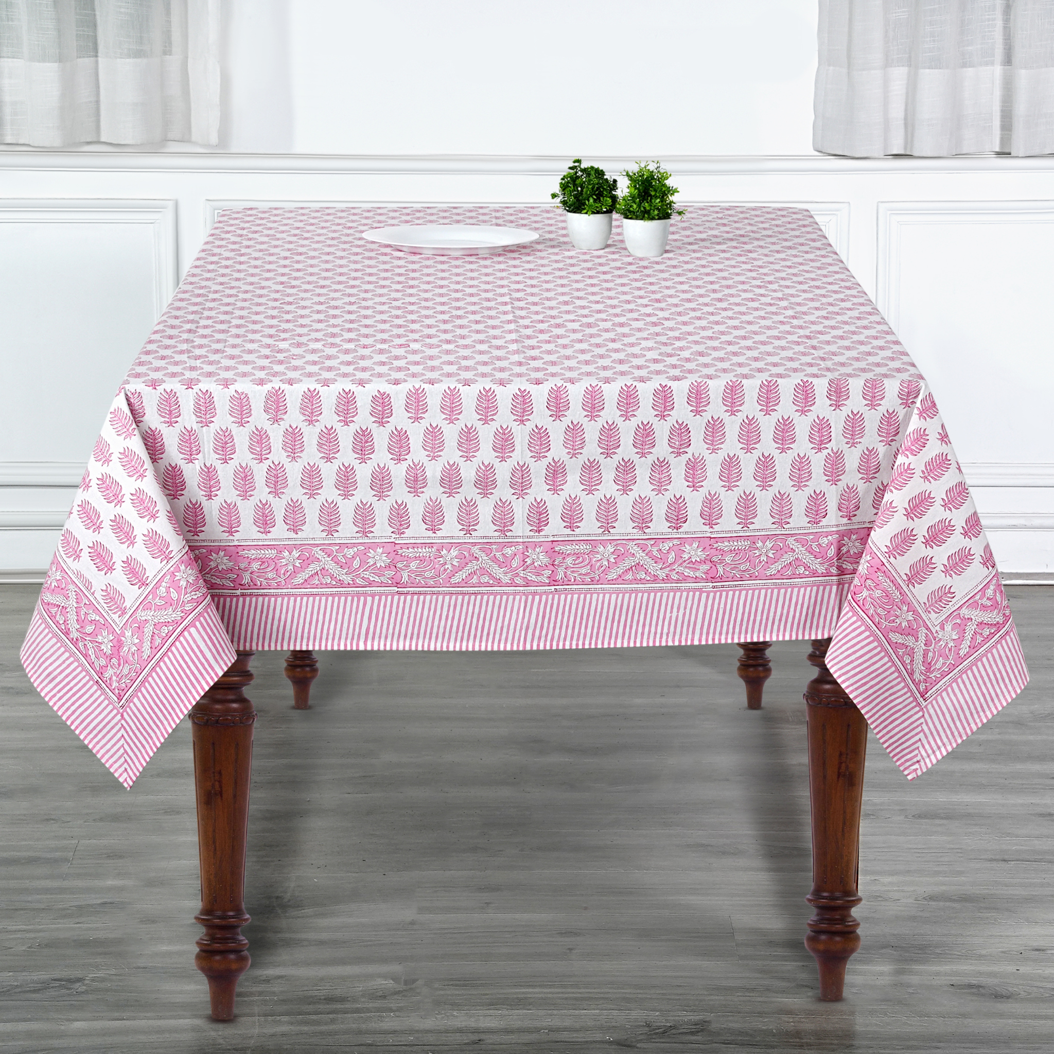 Tablecloth with pink and white pattern on a wooden table