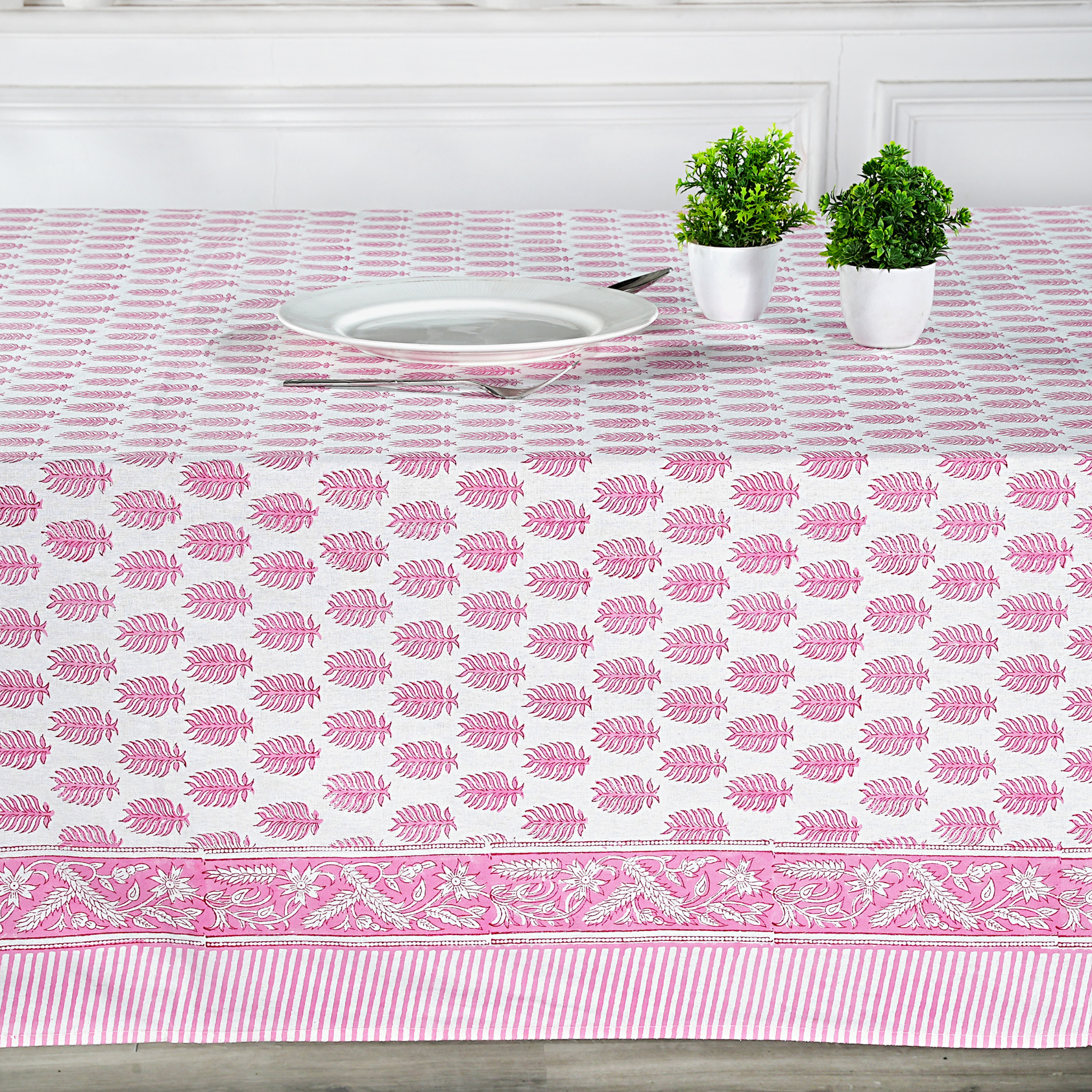 Tablecloth with pink leaf pattern on a dining table