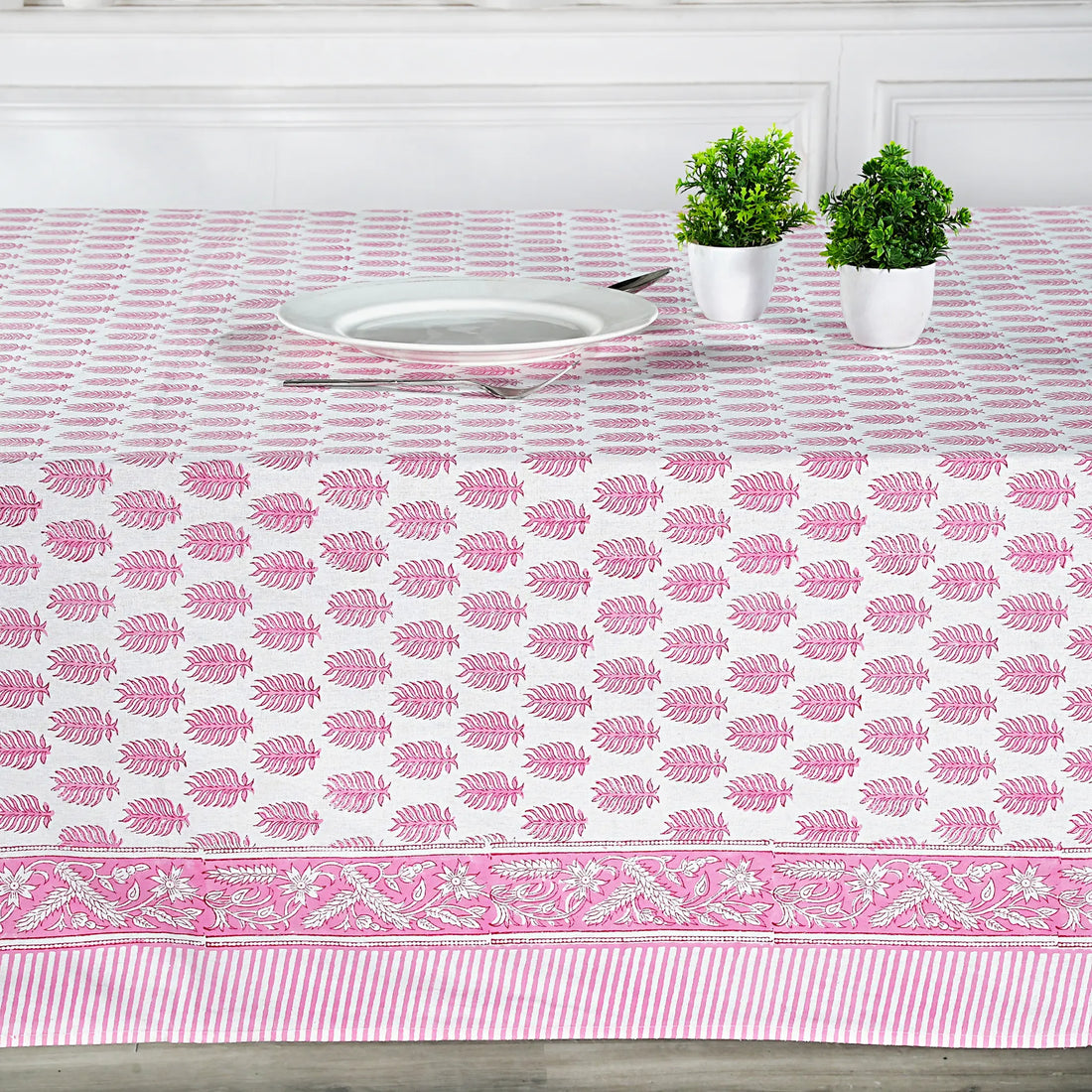 Tablecloth with pink leaf pattern on a dining table