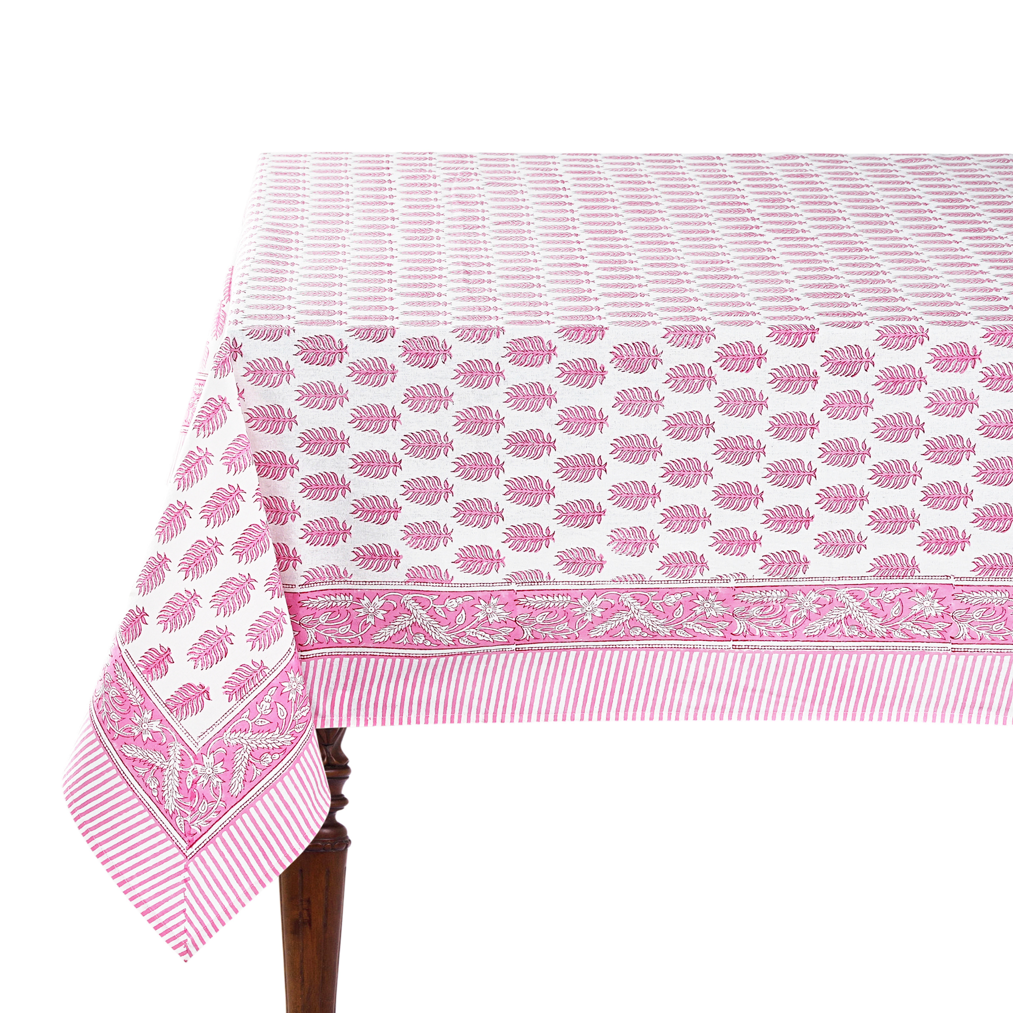 Pink and white patterned tablecloth on a wooden table