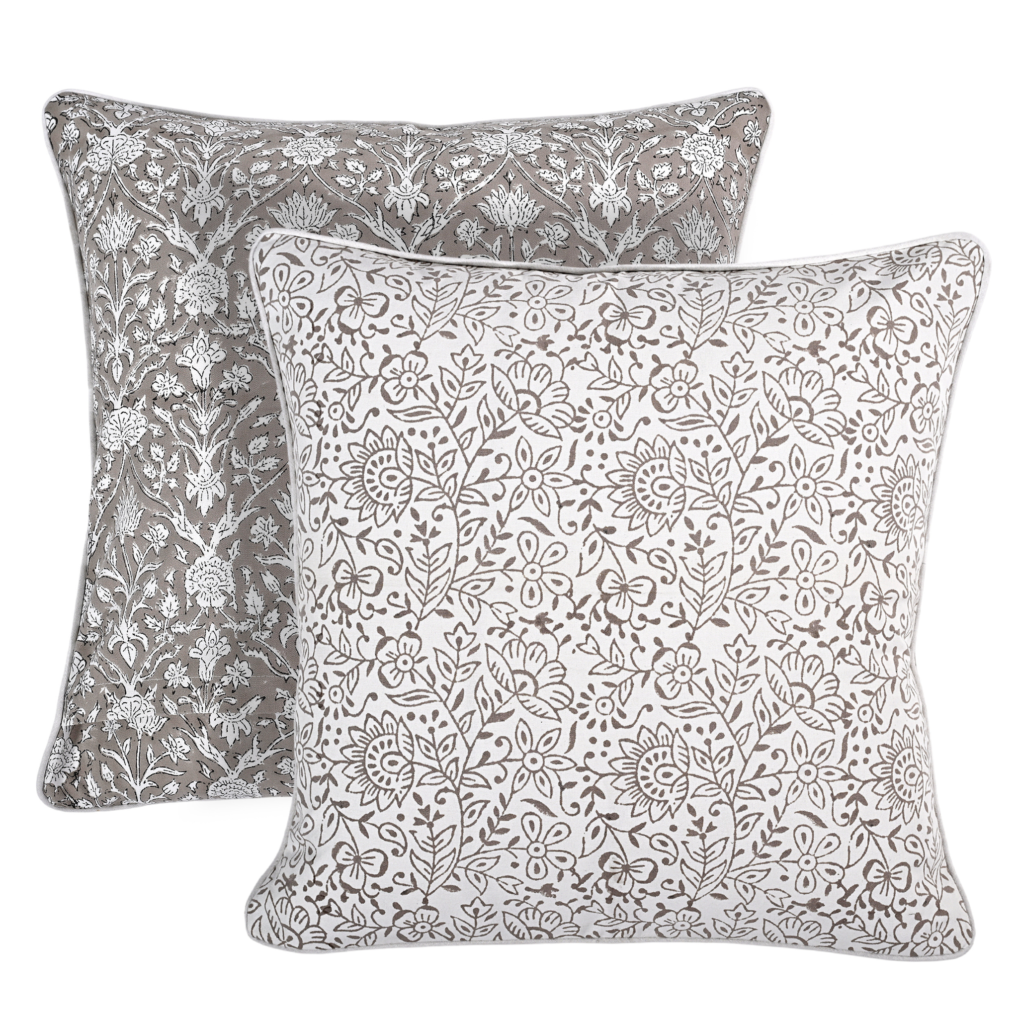 Two floral-patterned pillows on a white background
