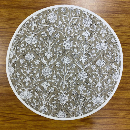 Round placemat with floral pattern on a wooden surface