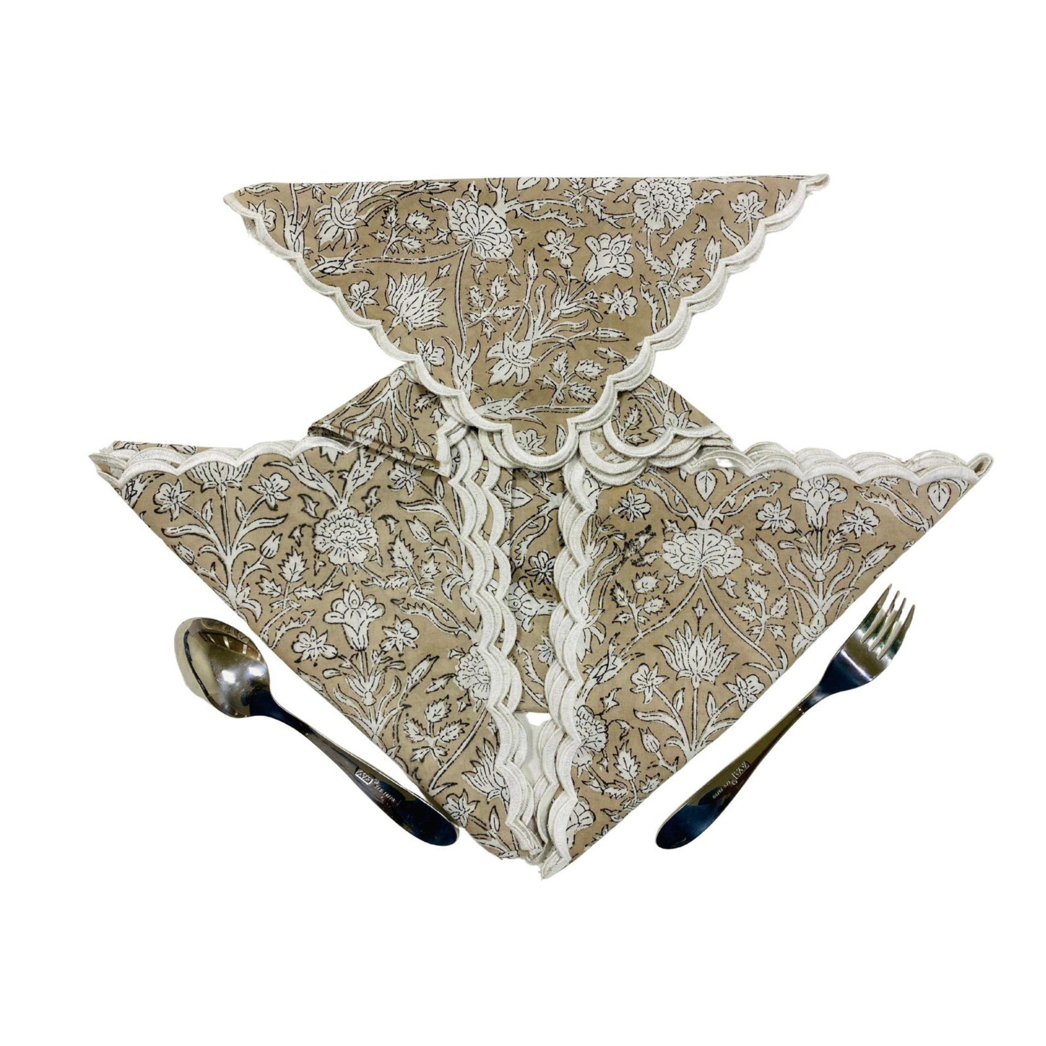 Set of floral-patterned napkins with cutlery on a white background