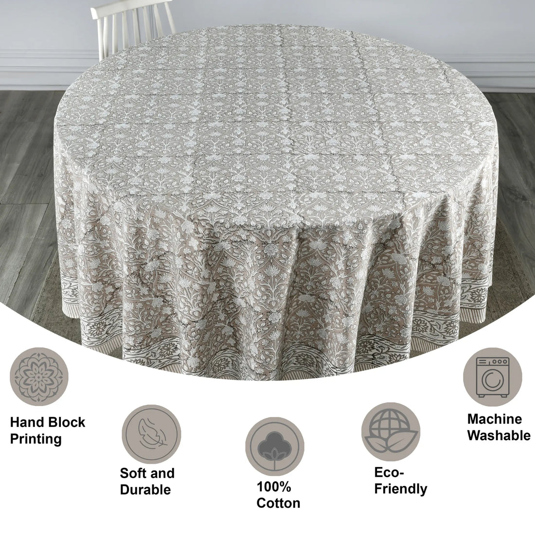 Round tablecloth with floral pattern on a wooden floor, featuring icons and text about material and care.