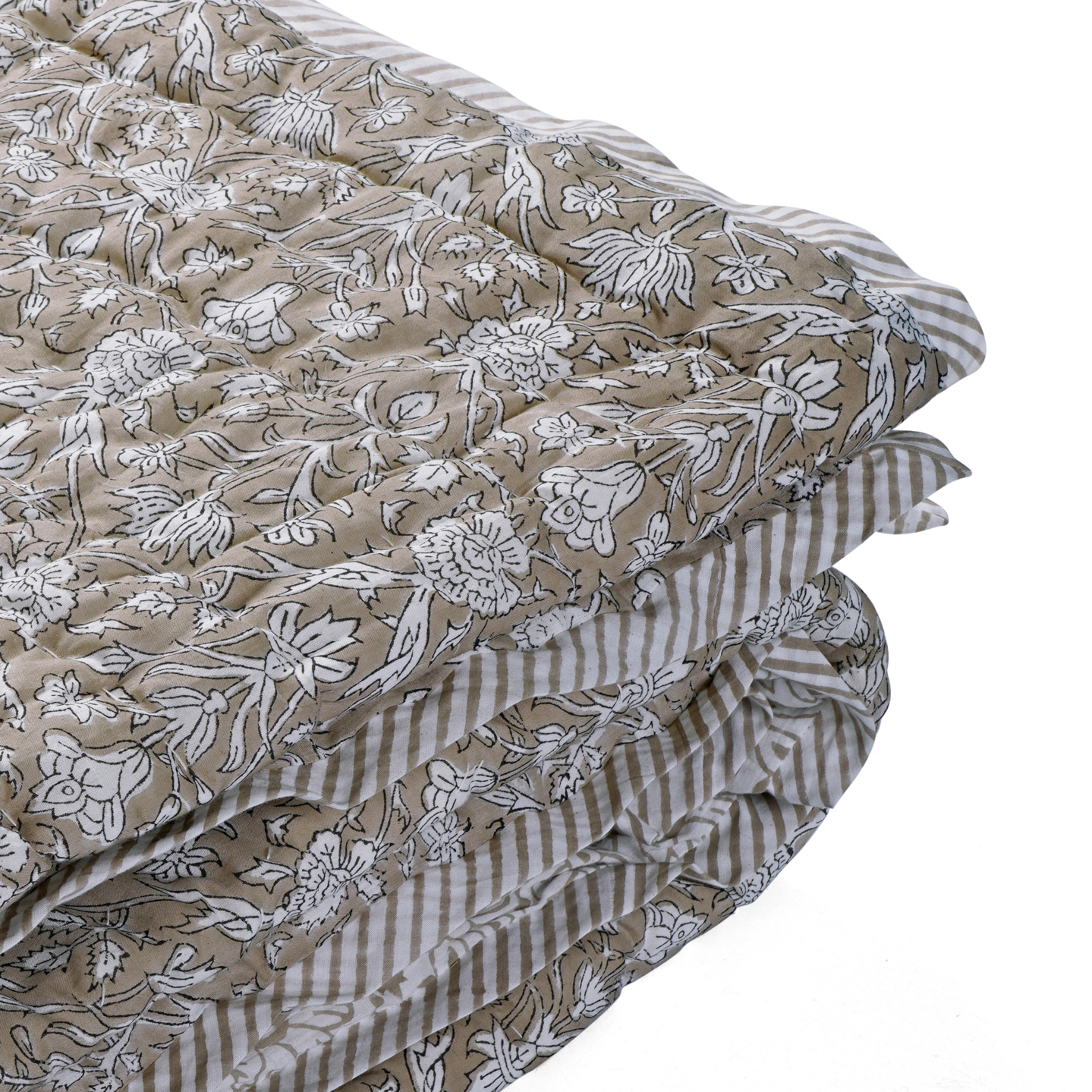 Stack of fabric sheets with floral and striped patterns on a white background