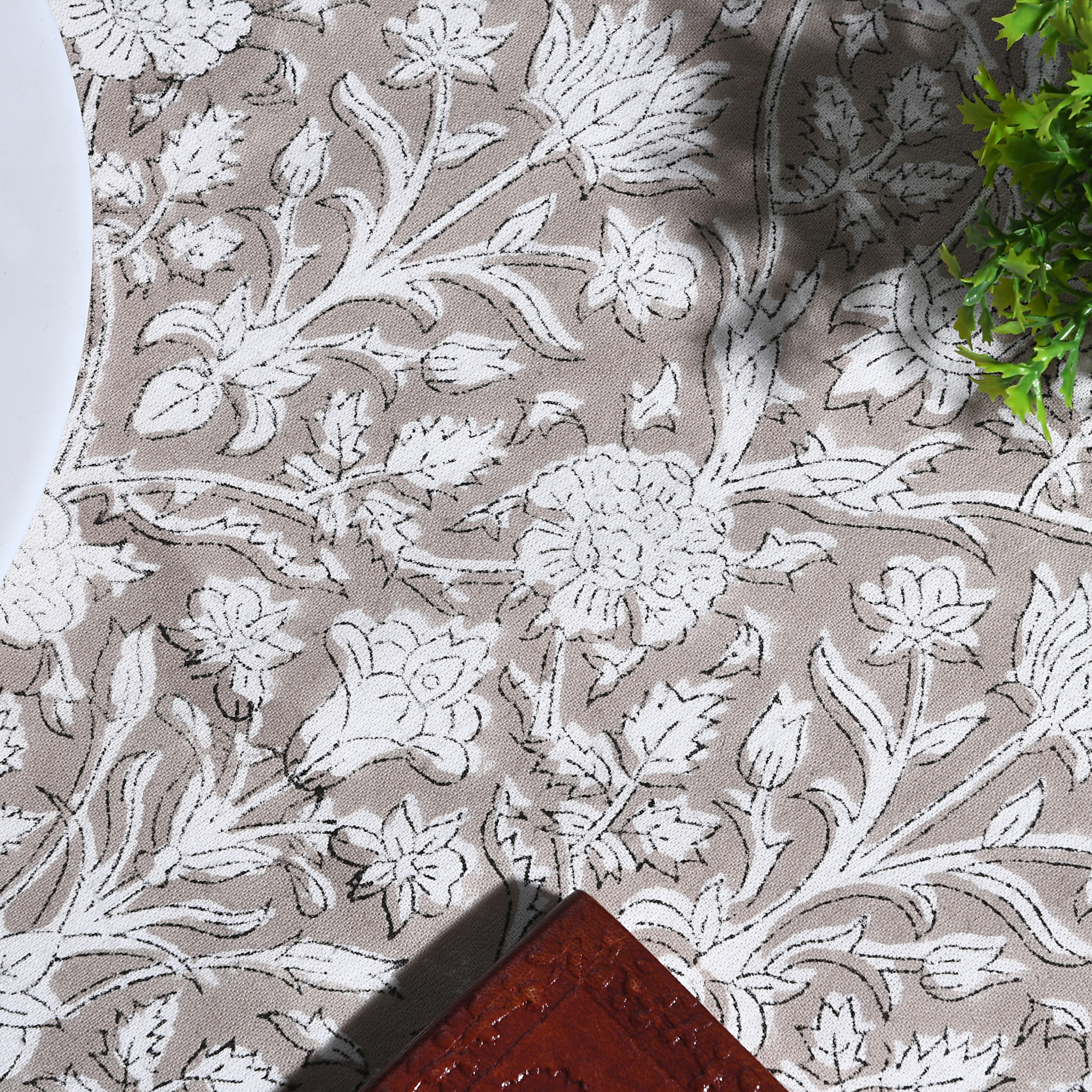 Floral patterned fabric with white flowers on a beige background