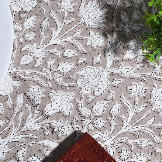 Floral patterned fabric with white flowers on a beige background