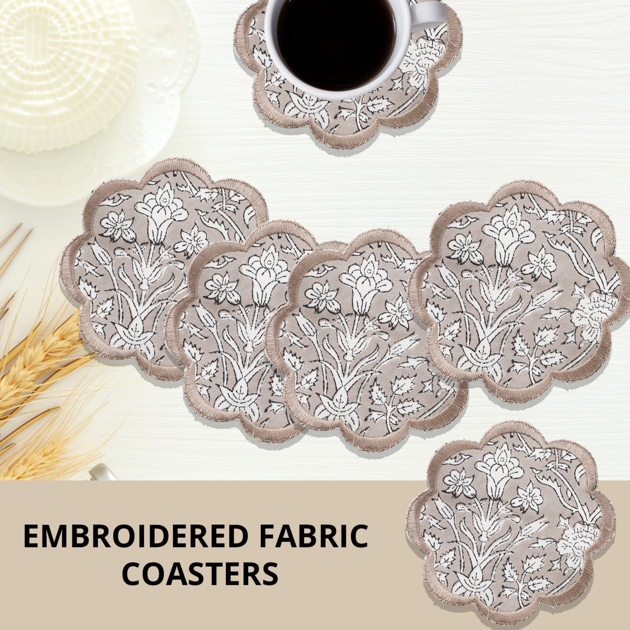 Set of embroidered fabric coasters with floral patterns on a neutral background.