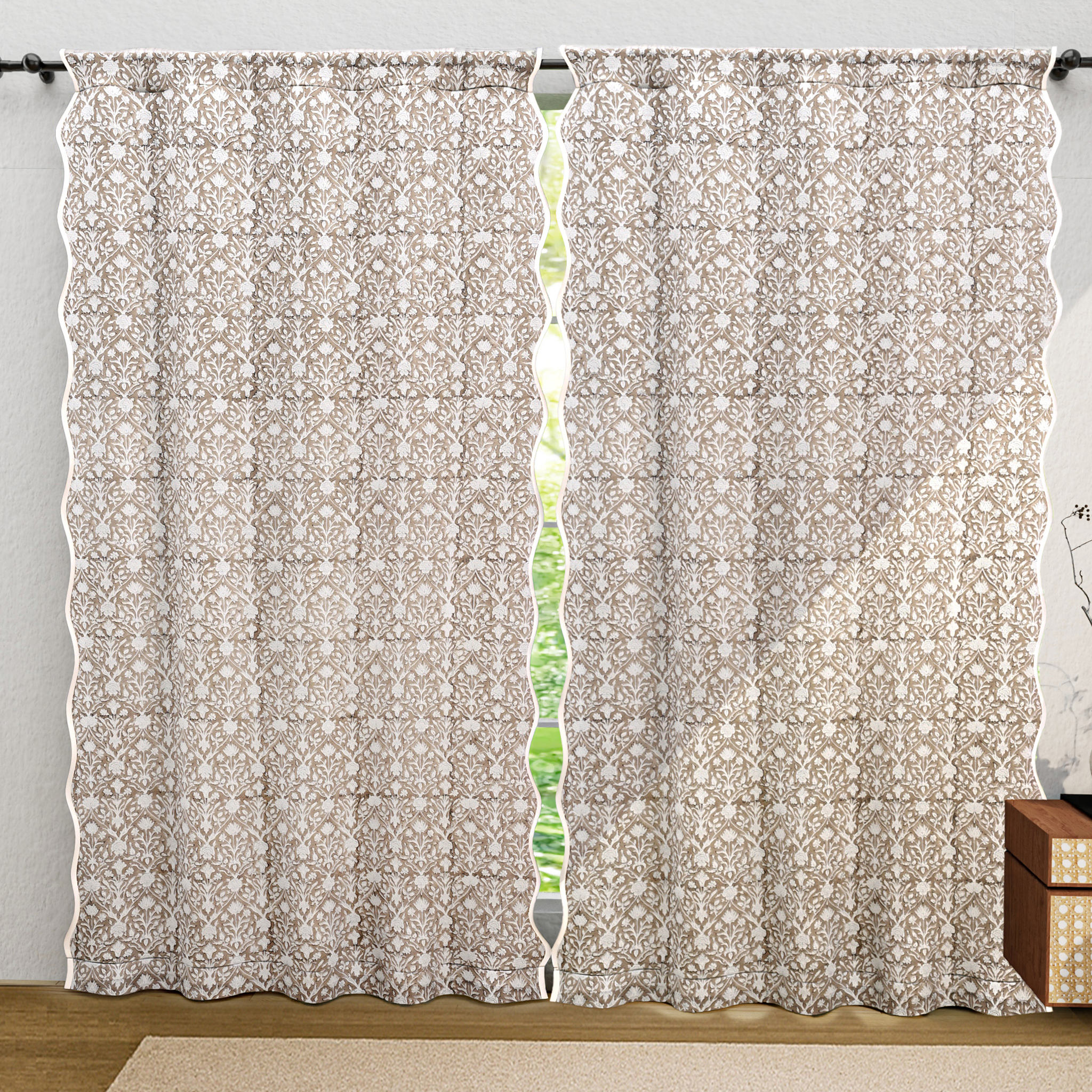 Floral patterned curtain with a visible light filter on a gray wall background