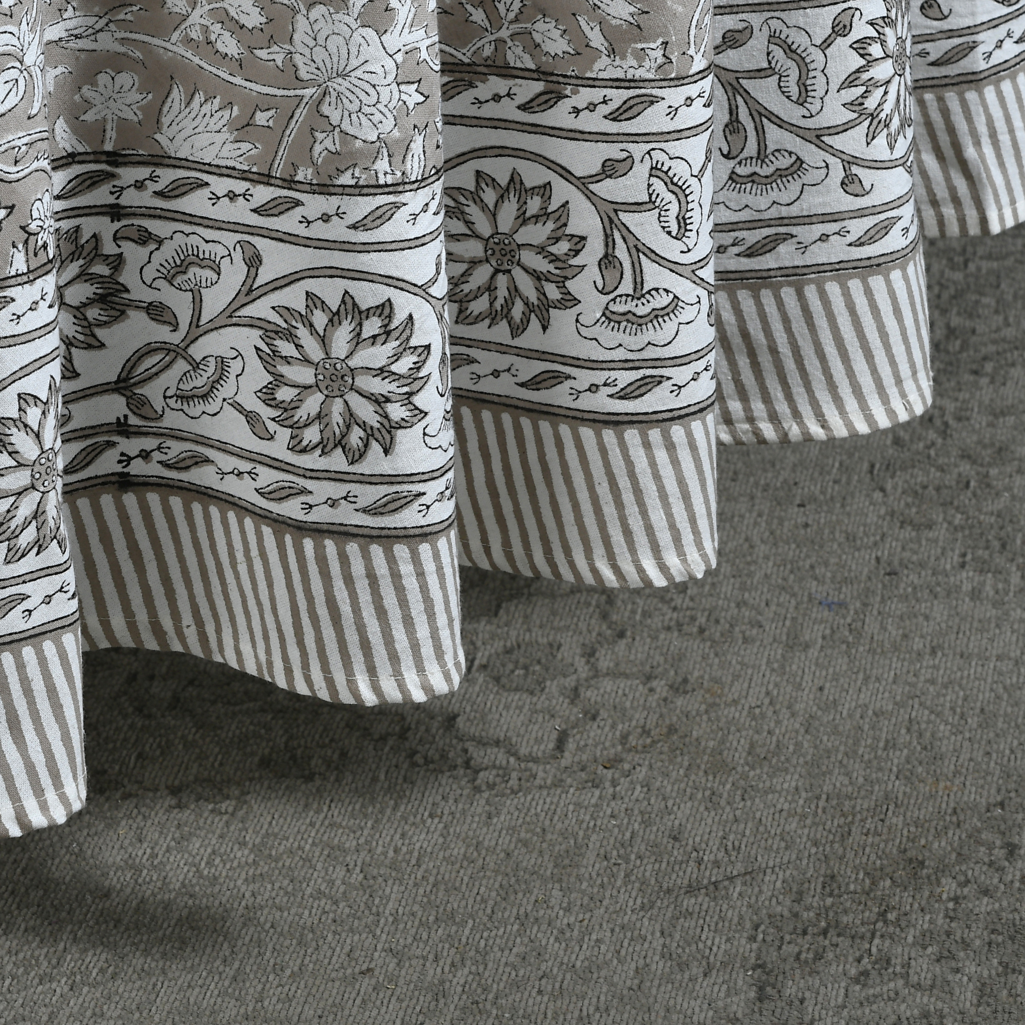 Close-up of patterned curtains on a textured surface