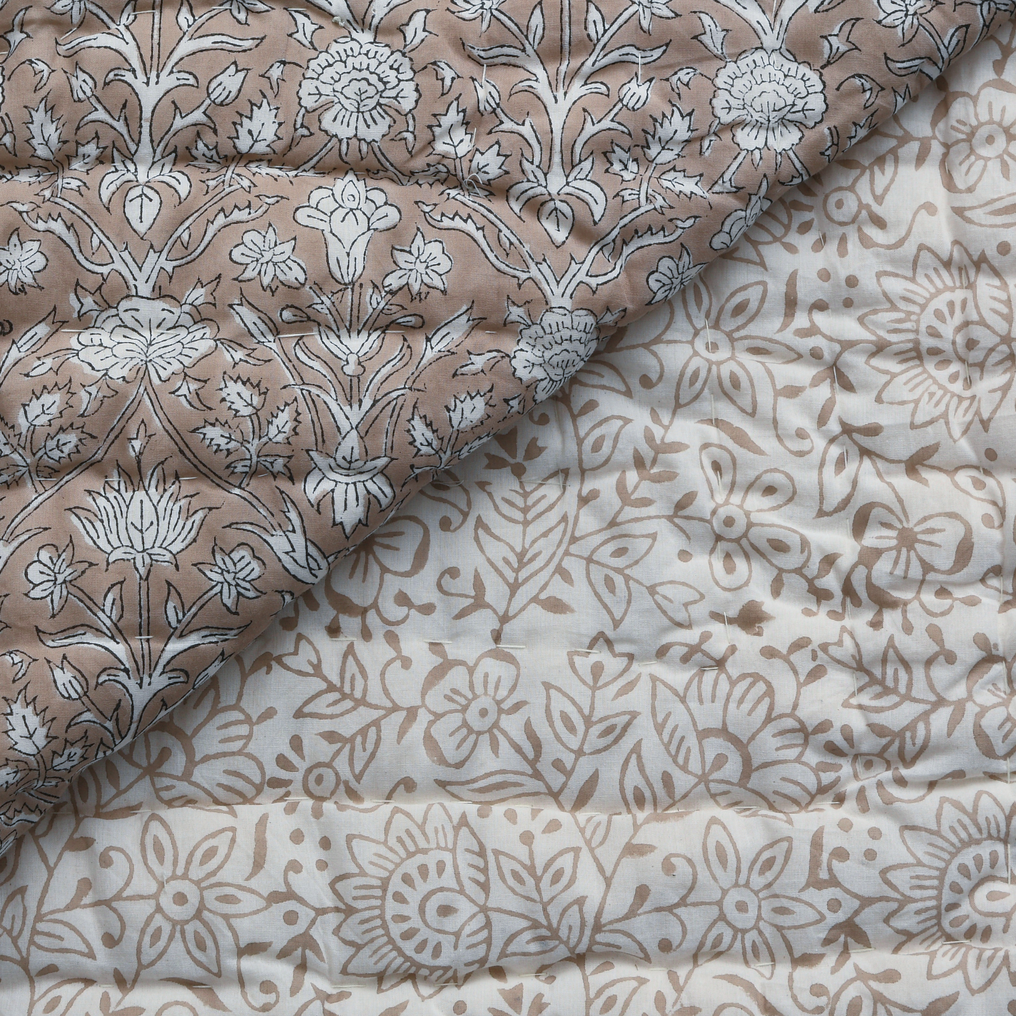 Two pieces of fabric with floral patterns, one in brown and white, the other in beige and white.