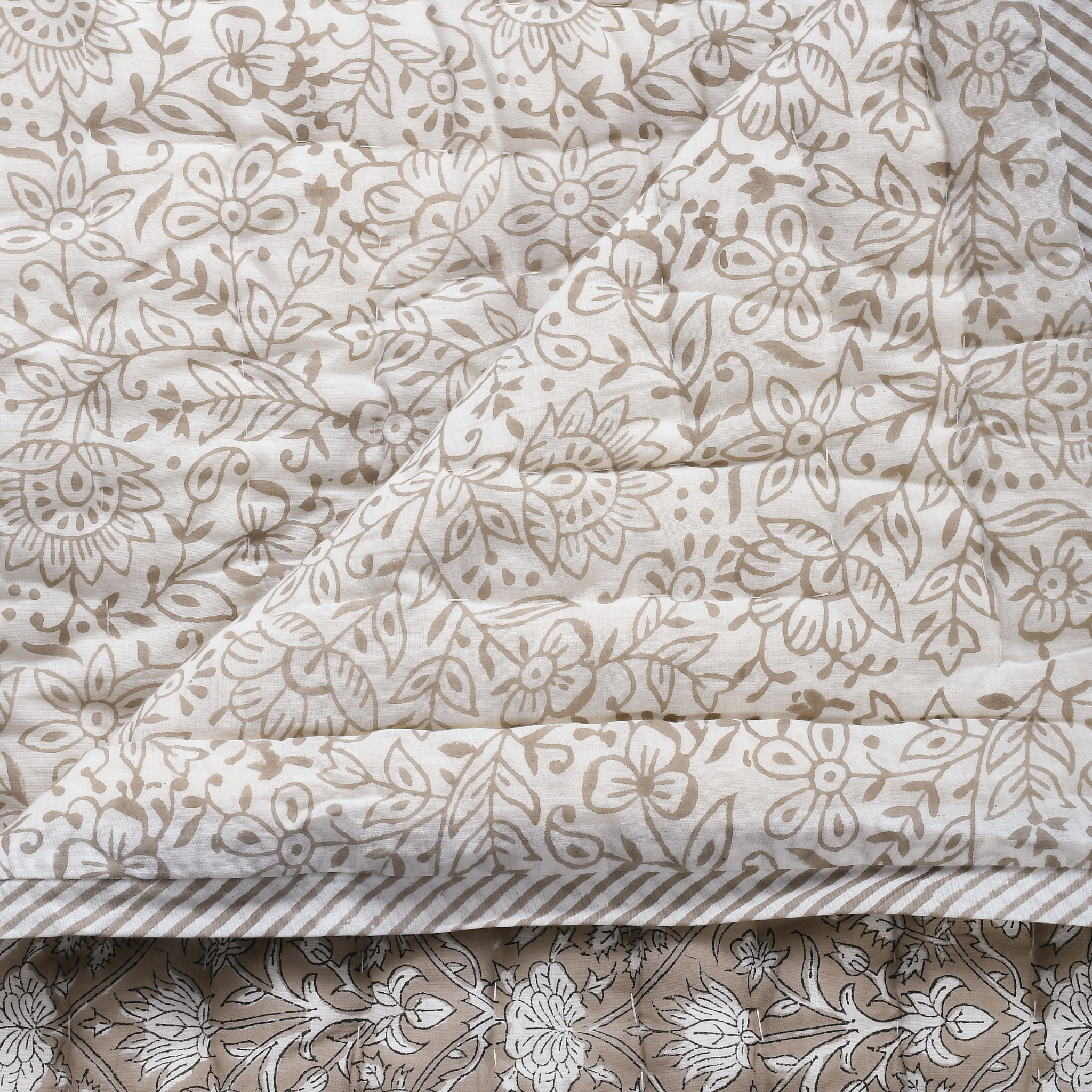 Floral patterned fabric with a beige and white color scheme.