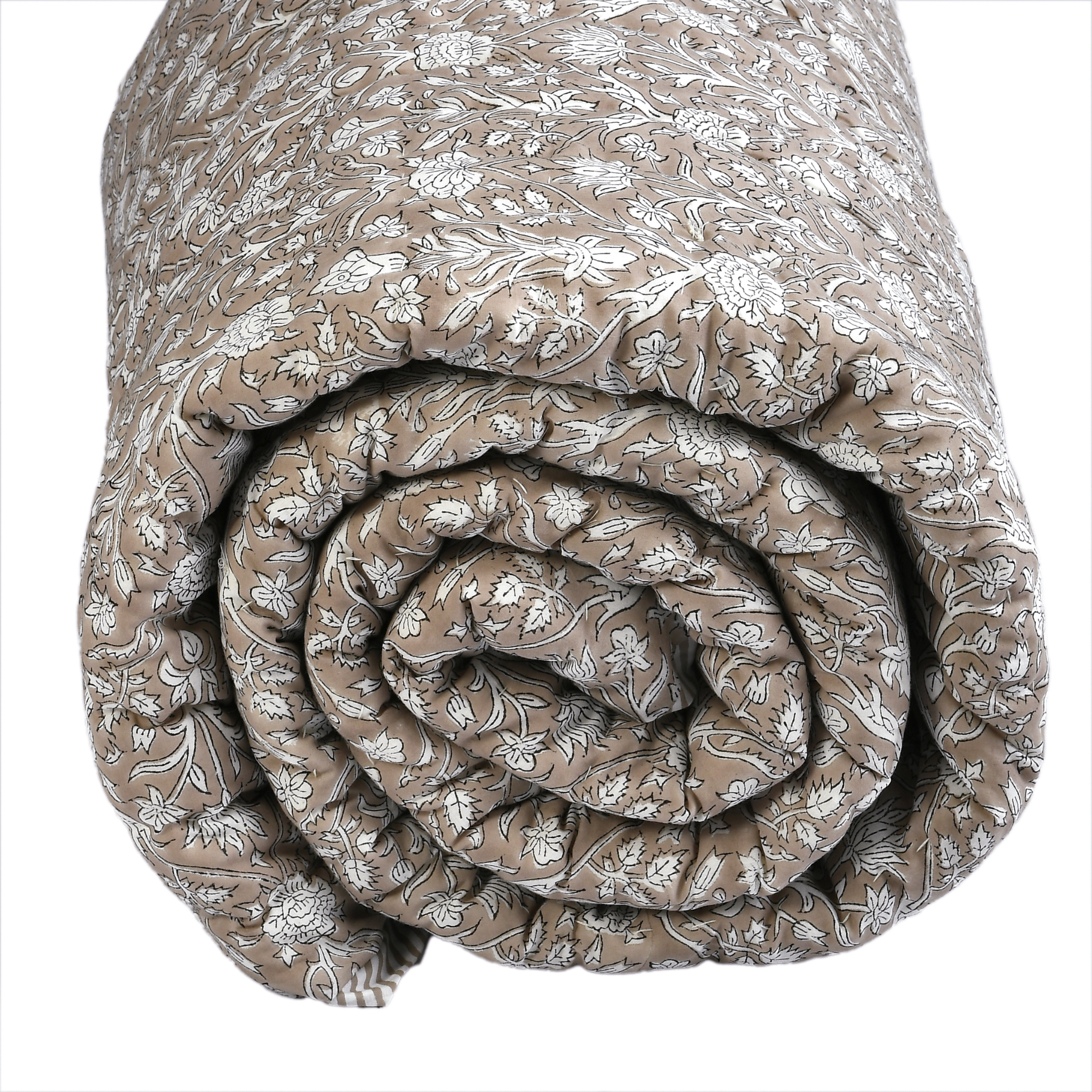 Rolled-up floral-patterned quilt on a white background