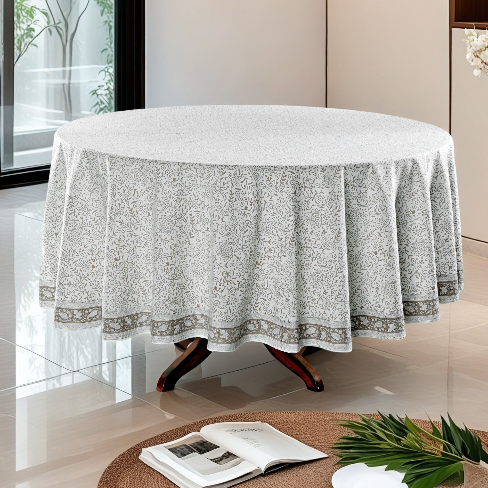 Round table with a decorative tablecloth in a modern room.