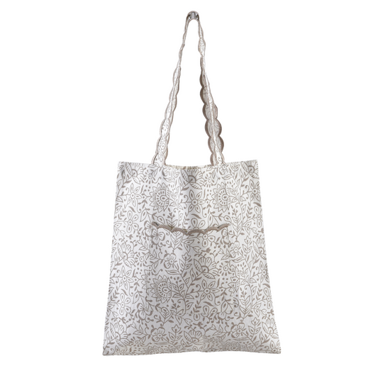 White tote bag with gray floral pattern on a white background