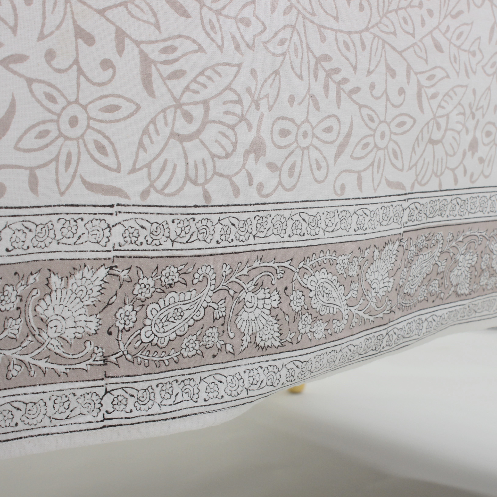 Close-up of a fabric with intricate paisley and floral patterns.