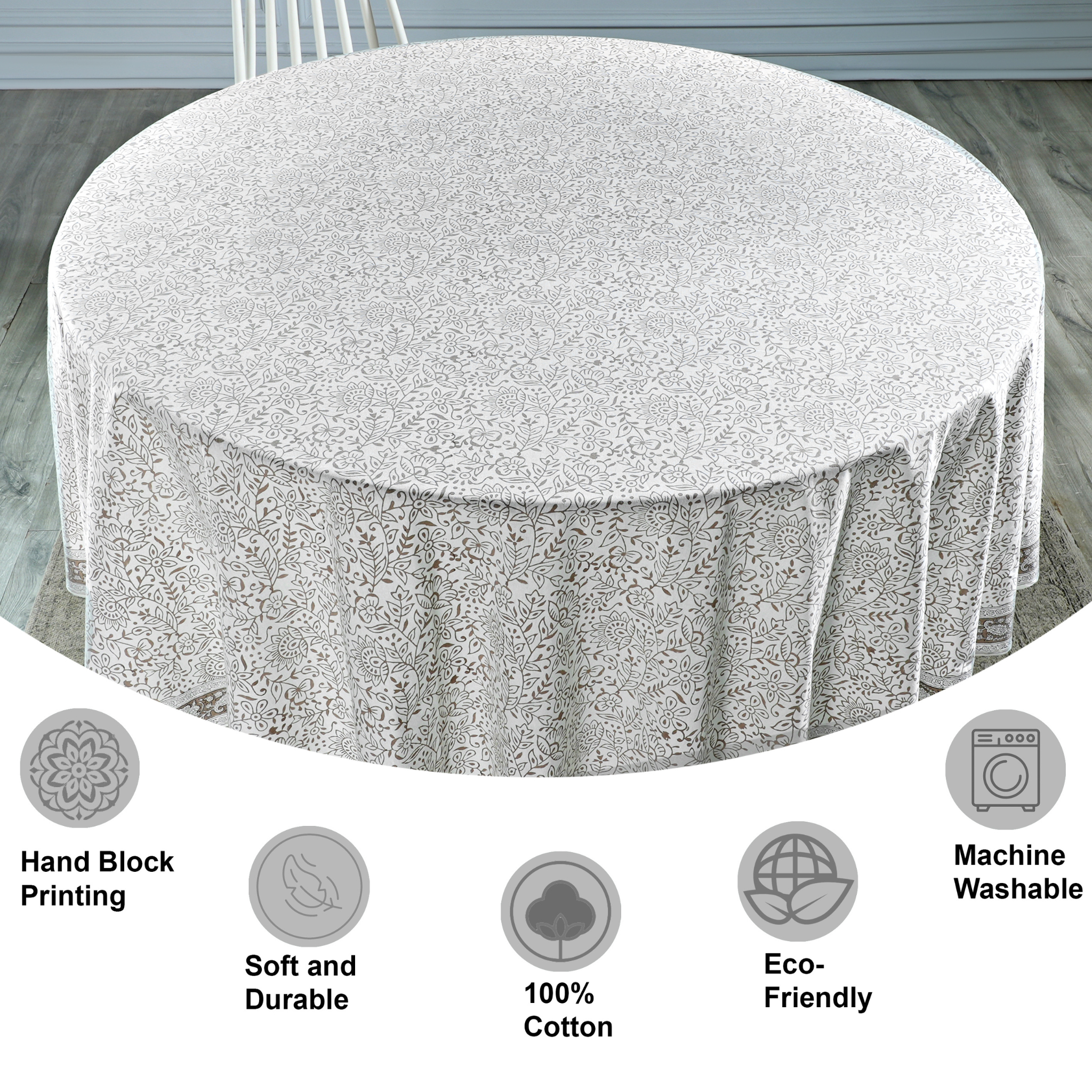 Round tablecloth with floral pattern on a table, featuring icons and text about material and care.