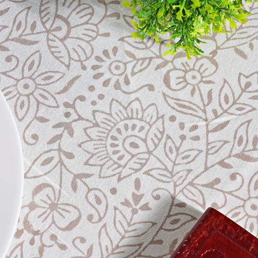 Floral patterned fabric with a plant and red object in the background