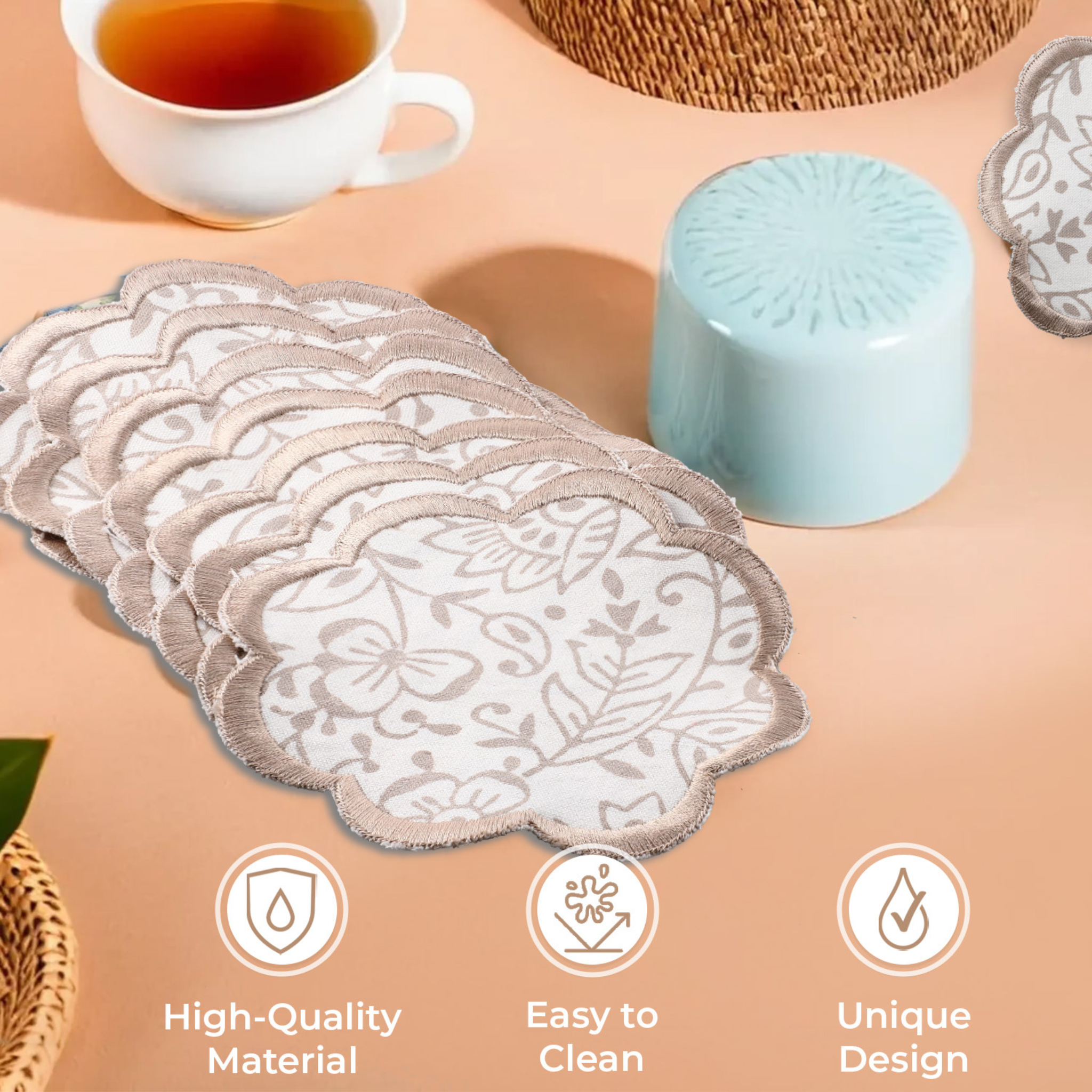 Set of lace coasters on a table with tea and decorative items.