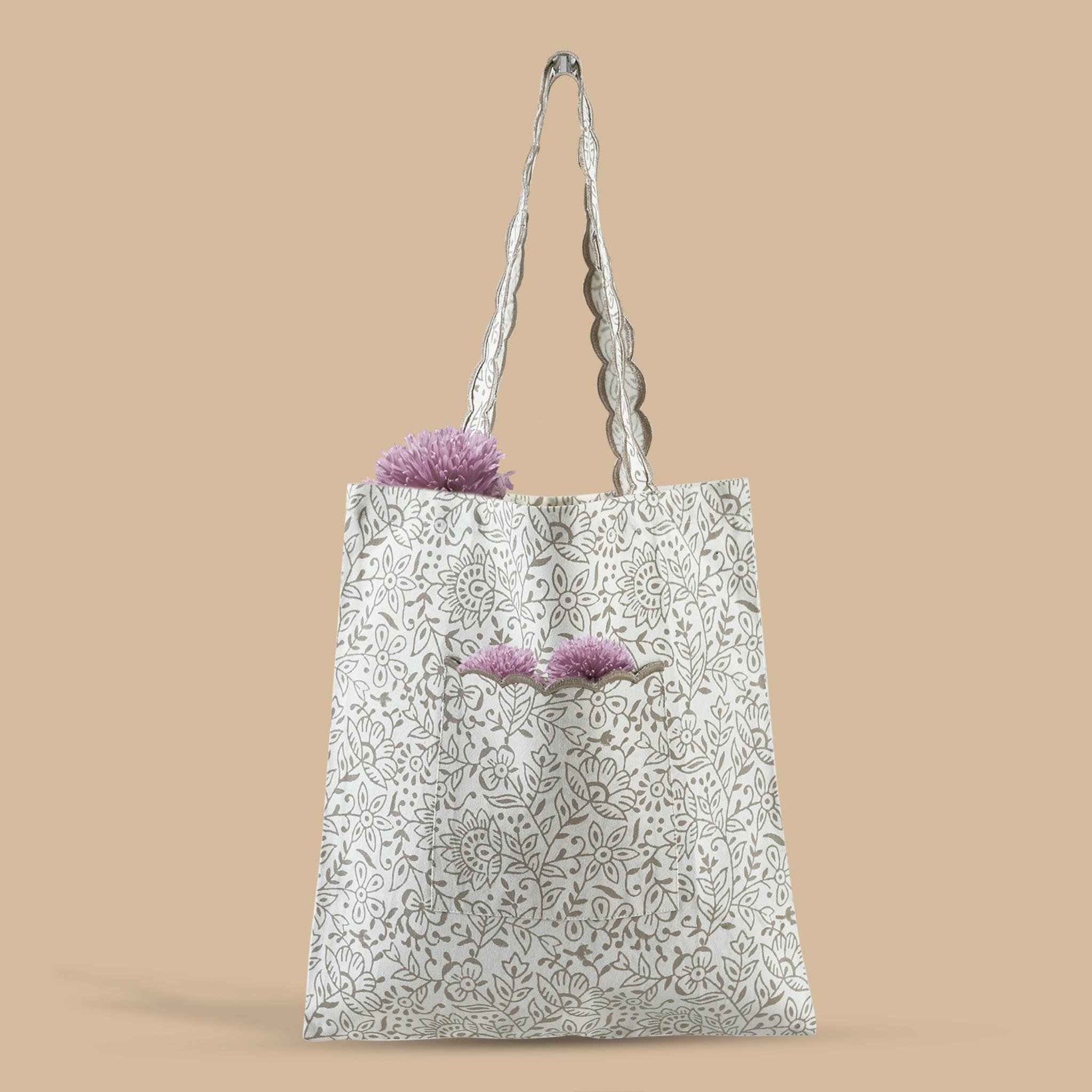 Tote bag with floral design and purple flowers on a beige background