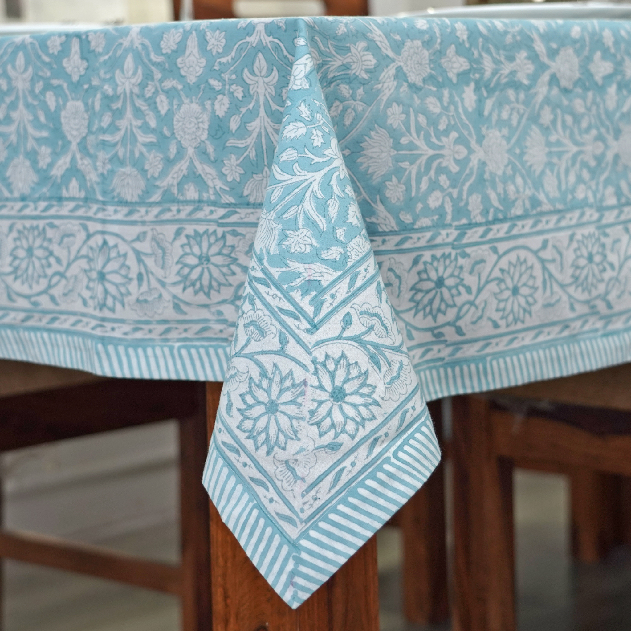 Blue and white patterned tablecloth on a wooden table