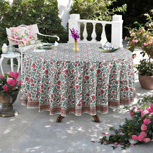 Round table with a floral tablecloth outdoors on a patio