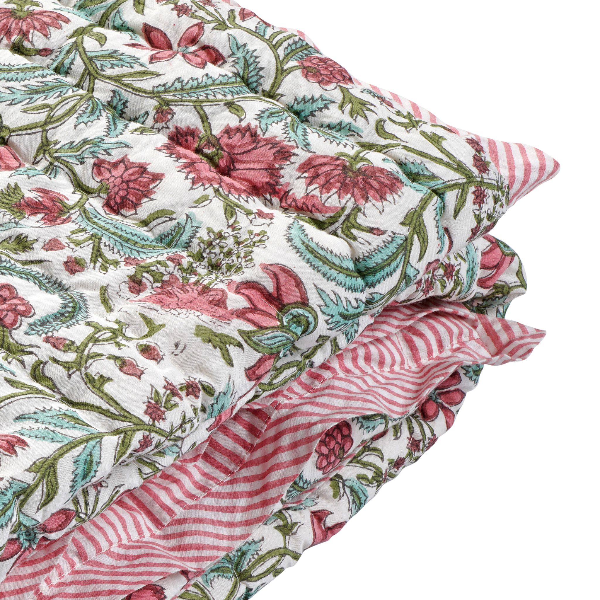 Stack of floral and striped fabric swatches on a white background