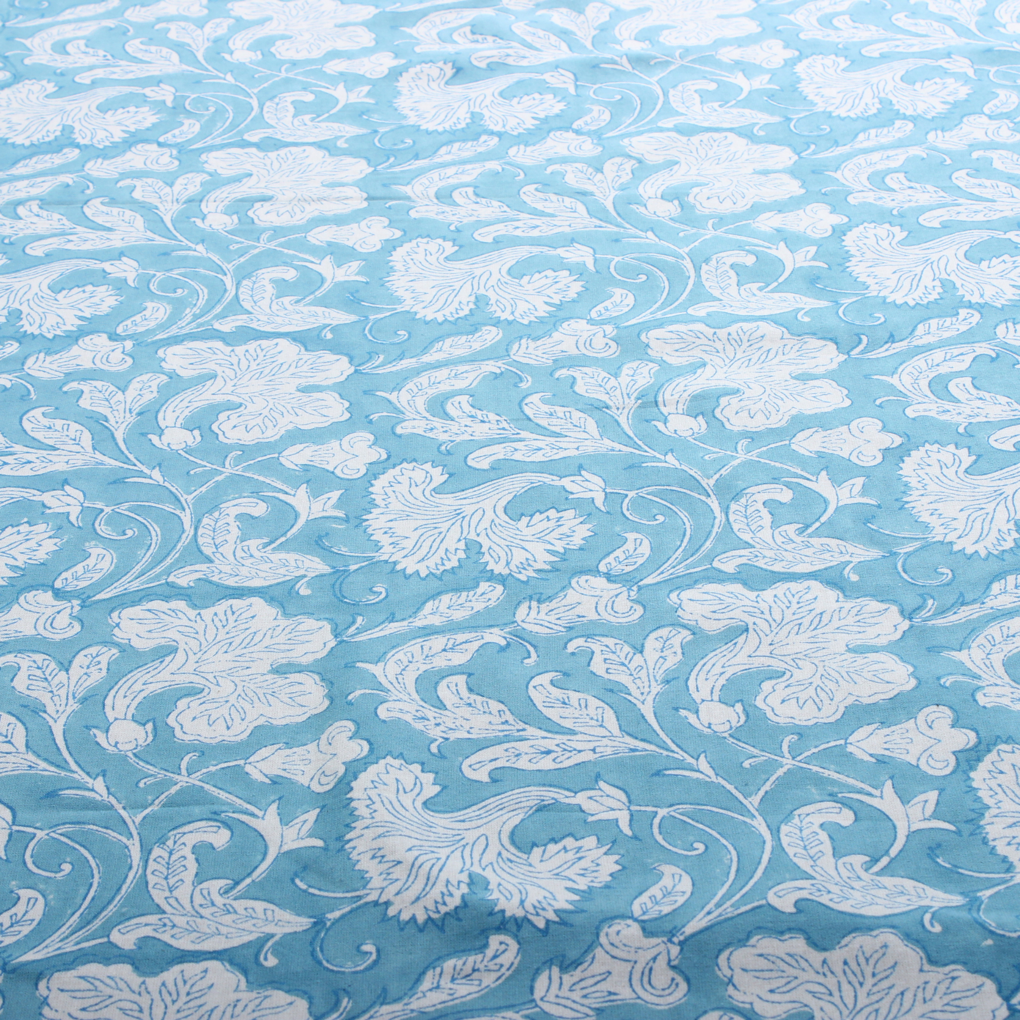 White floral pattern on a light blue background