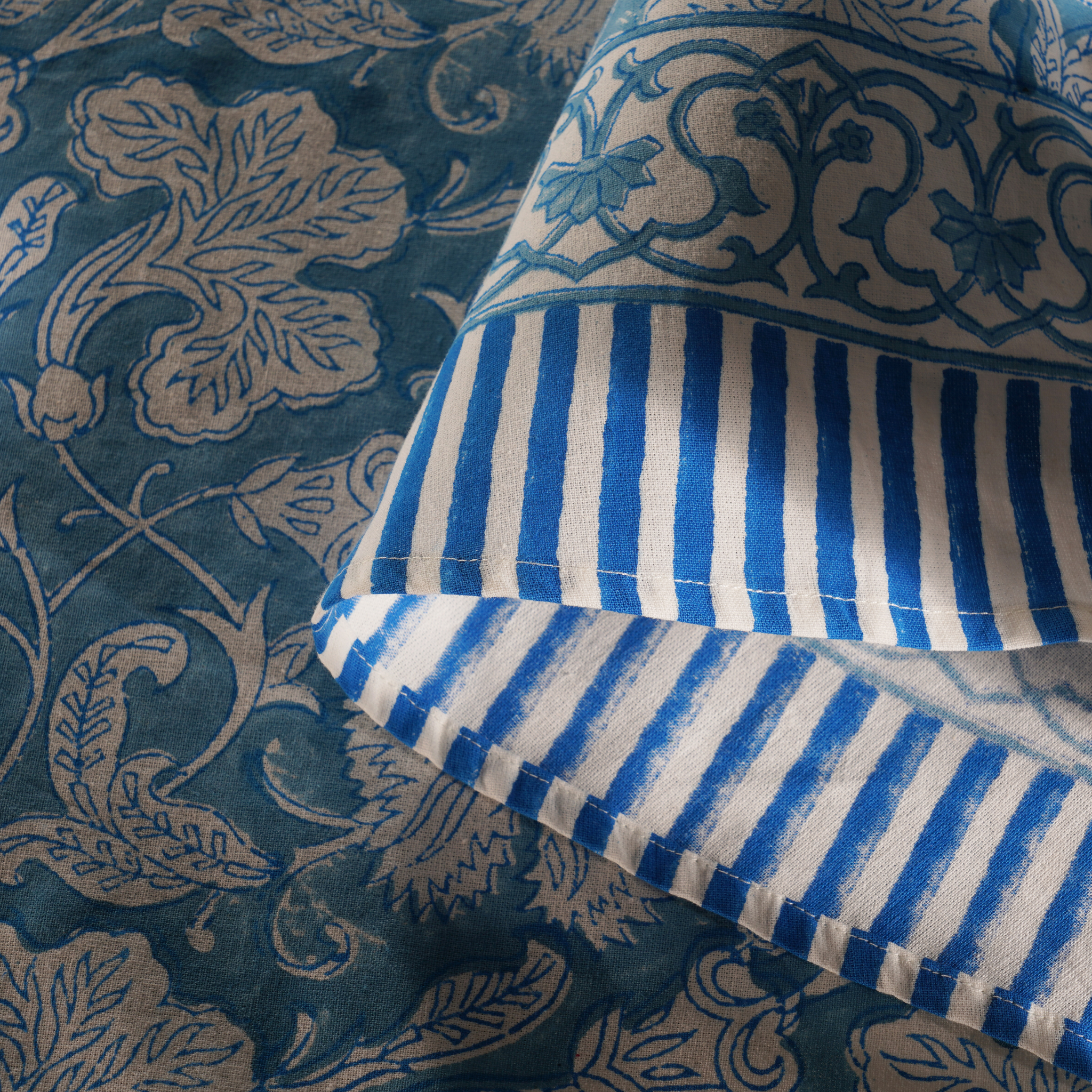 Close-up of blue and white striped fabric on a patterned background