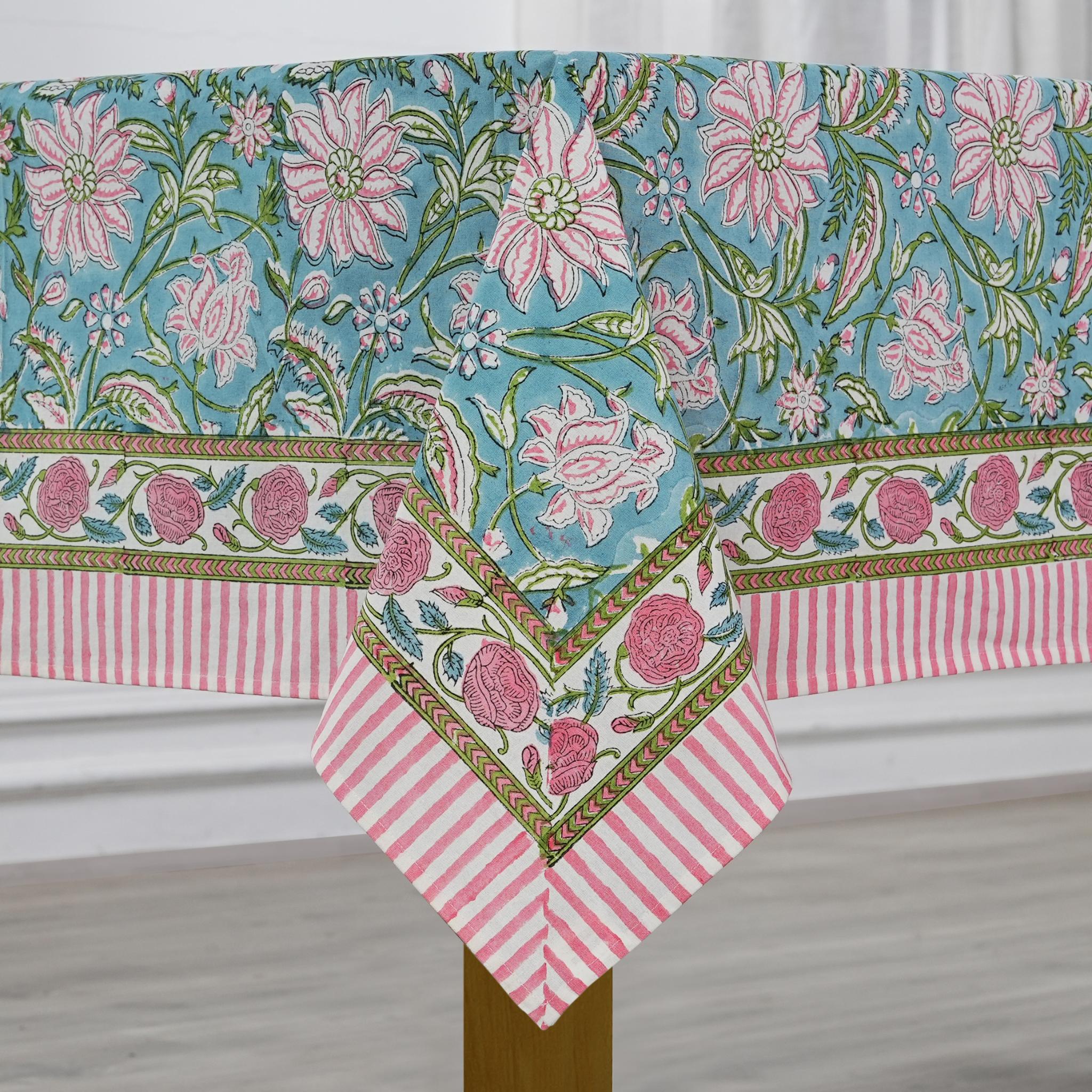 Floral and striped tablecloth on a wooden surface