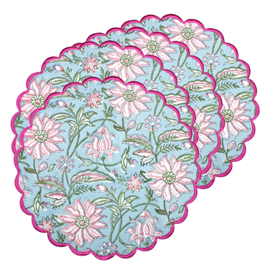 Set of floral coasters with pink flowers and green leaves on a blue background