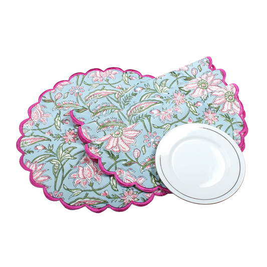 Floral placemats with pink and green design on a white background