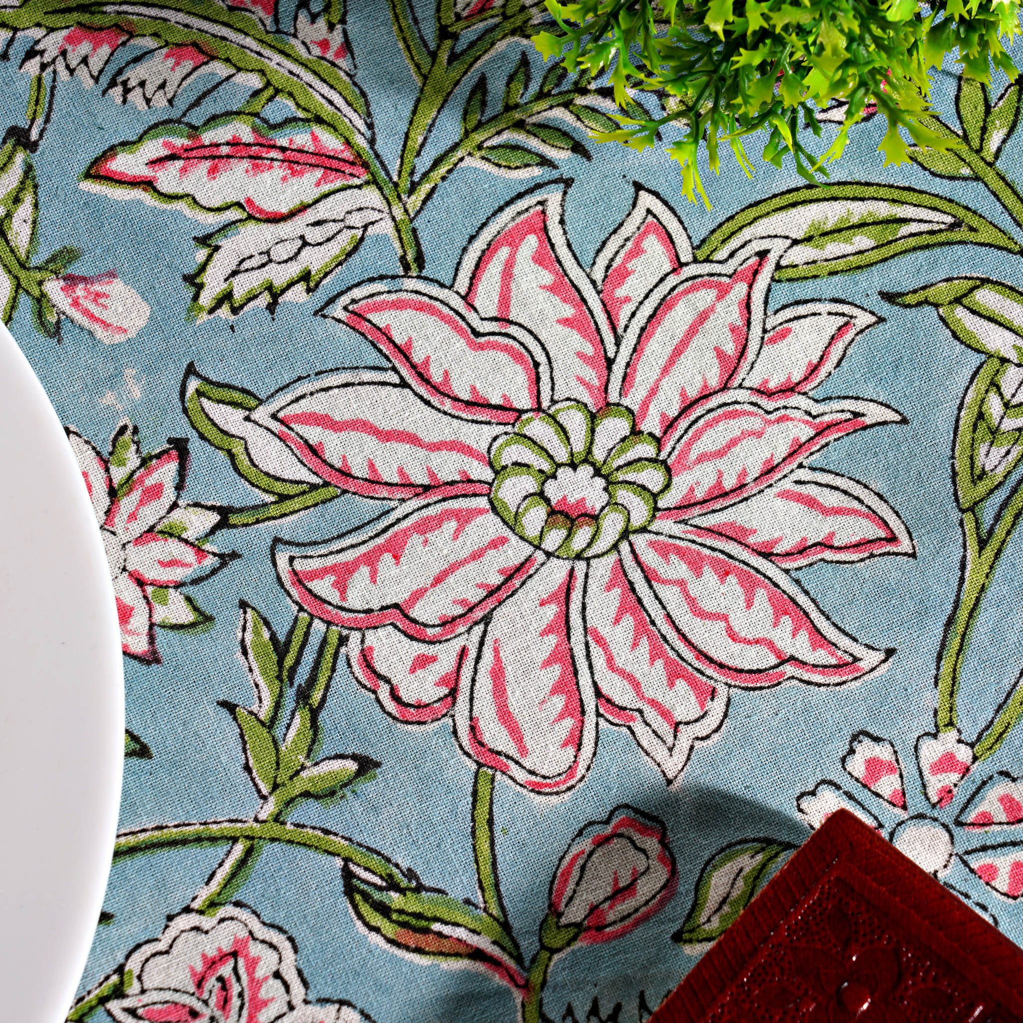 Floral patterned fabric with pink flowers on a blue background