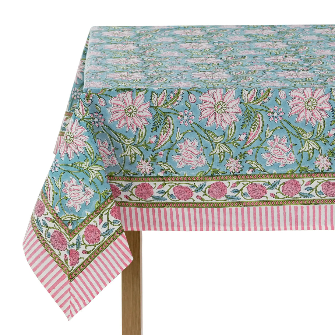 Floral patterned tablecloth with pink flowers and green leaves on a white background